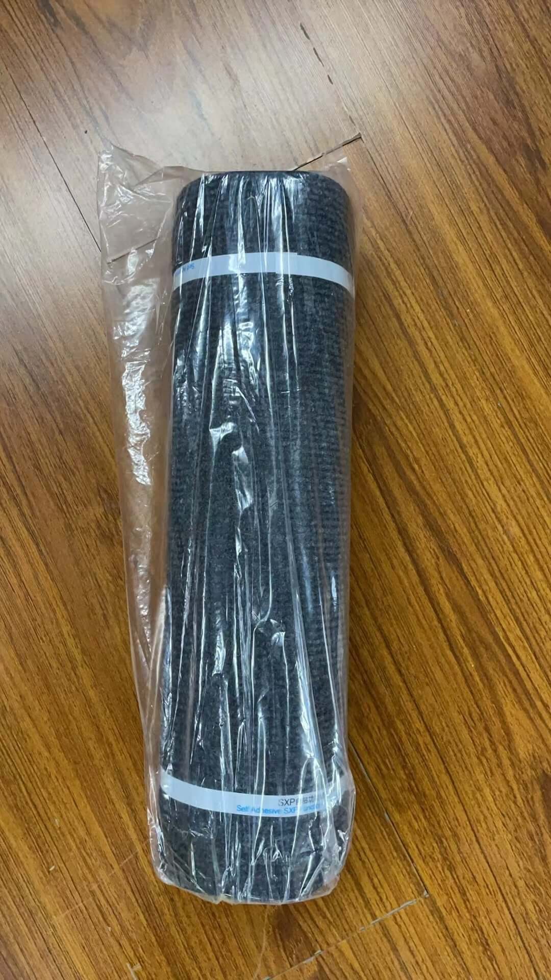 Shopi Vella self-adhesive cat scratch board rolled up and packaged on wooden floor