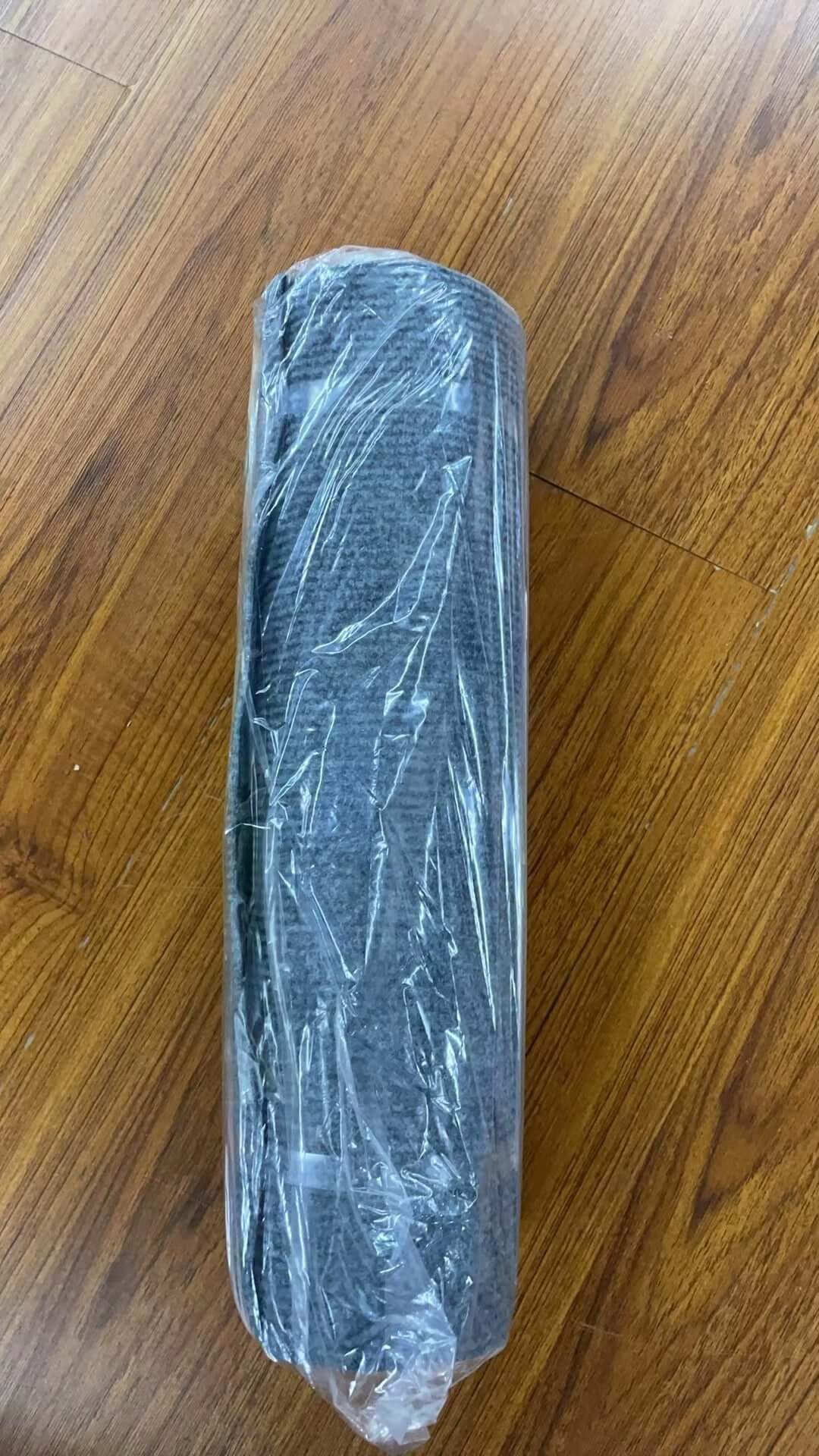 Shopi Vella self-adhesive cat scratch board rolled and wrapped in plastic packaging on wooden floor