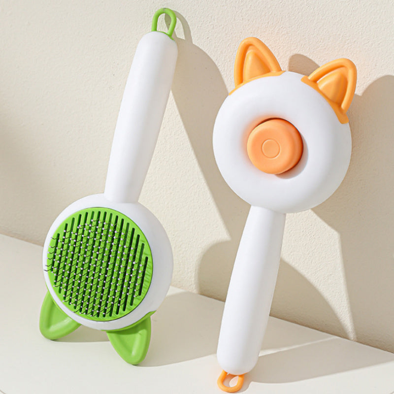 Shopi Vella self cleaning pet brush with cat ear design and green bristles for easy pet grooming