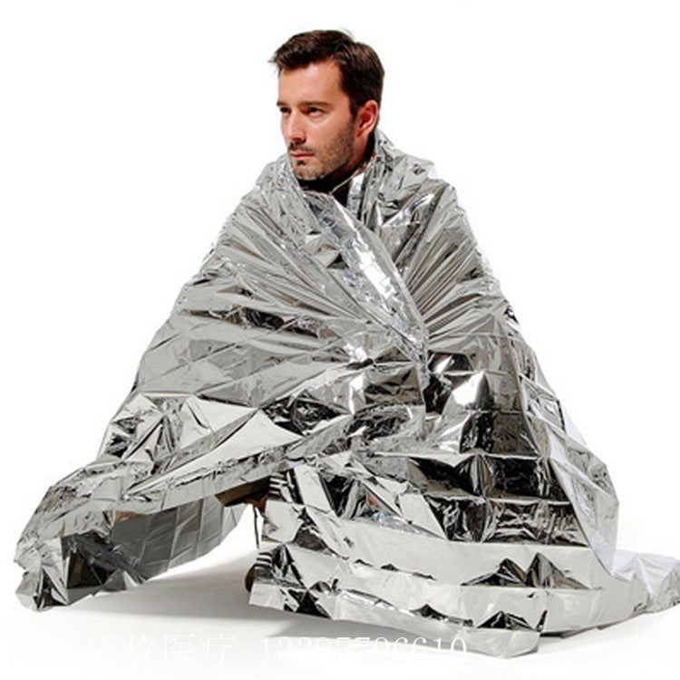 Shopi Vella portable survival blanket outdoor wrapped around a man for emergency warmth