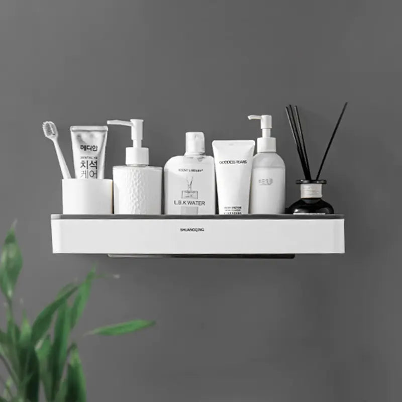 White wall mounted bathroom organizer holding toiletries and toothbrush with a minimalistic design