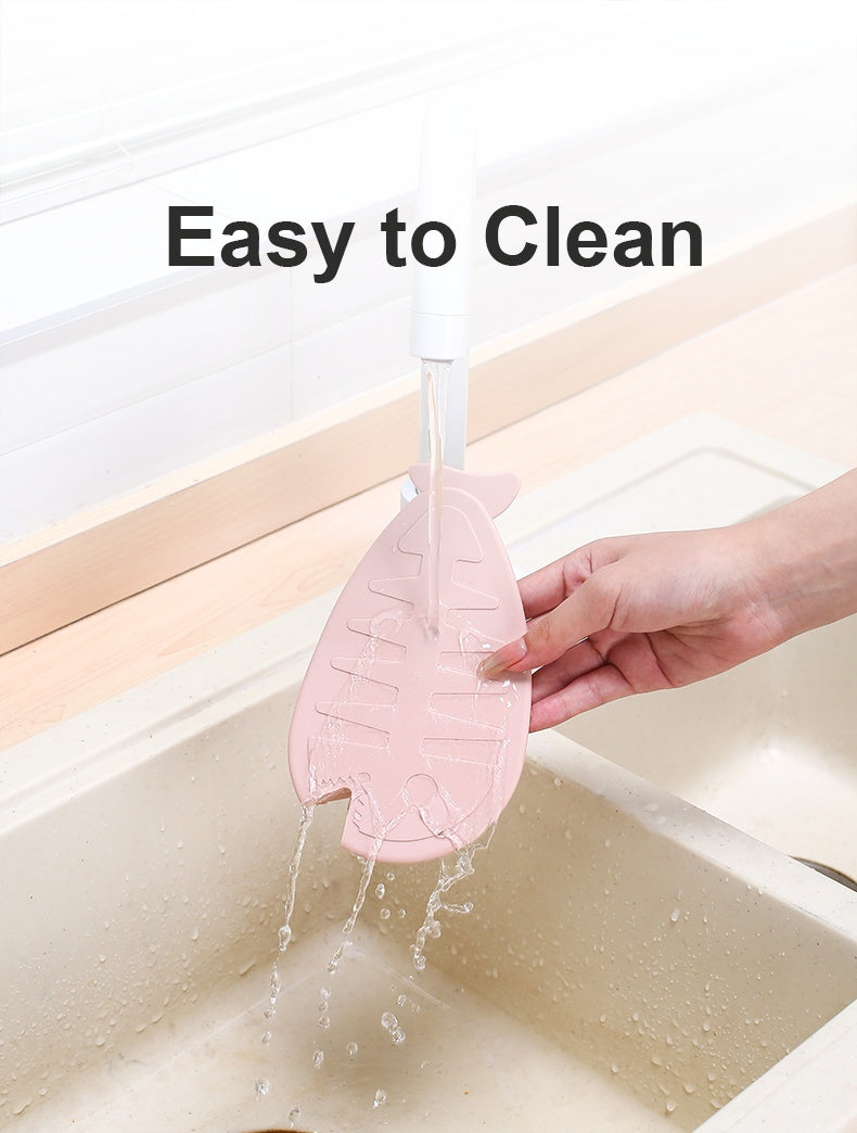 Shopi Vella silicone floor drain with hair catcher in pink being rinsed under sink faucet for easy cleaning