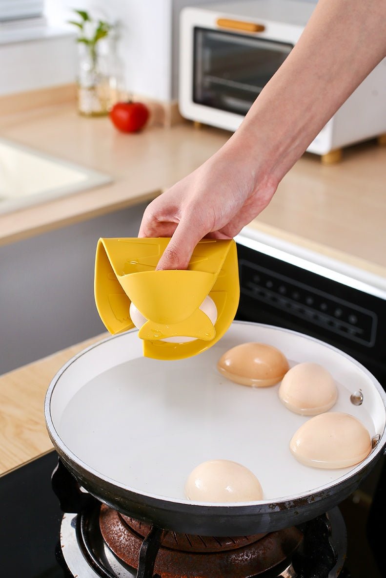 Shopi Vella yellow silicone floor drain with hair catcher held above hot cooking pan with dumplings