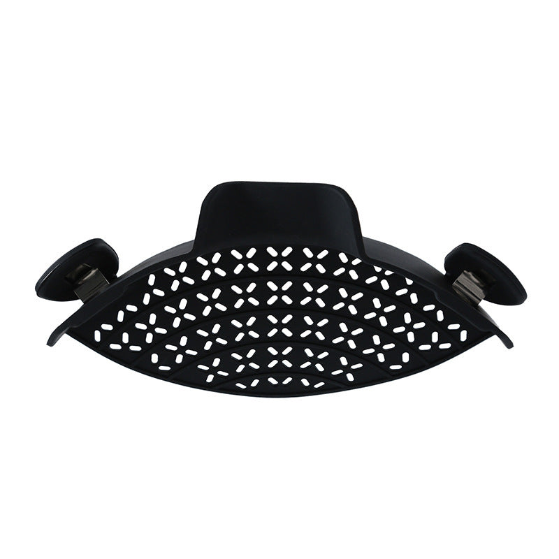 Black silicone pot side drain stopper with side clips for easy attachment to kitchen pots