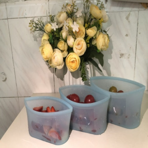 Shopi Vella reusable silicone food storage bags in three sizes holding strawberries and grapes