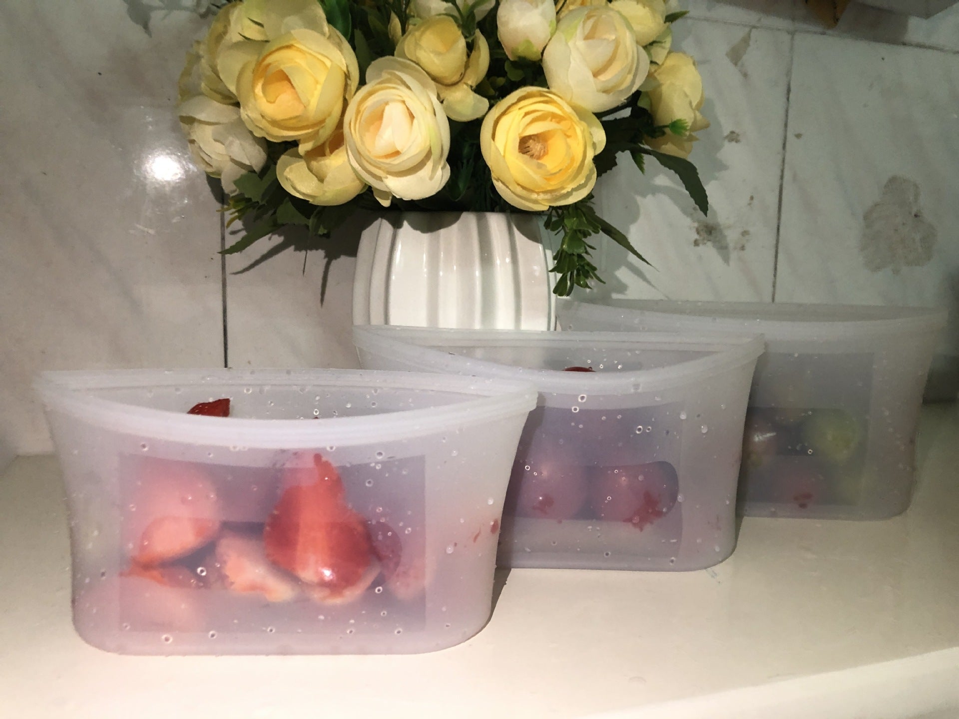 Shopi Vella reusable silicone food storage bags holding fresh strawberries on kitchen counter