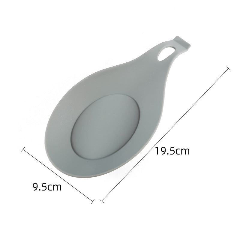 Gray silicone spoon rest for kitchen with a handle and measurement markings 19.5 by 9.5 centimeters