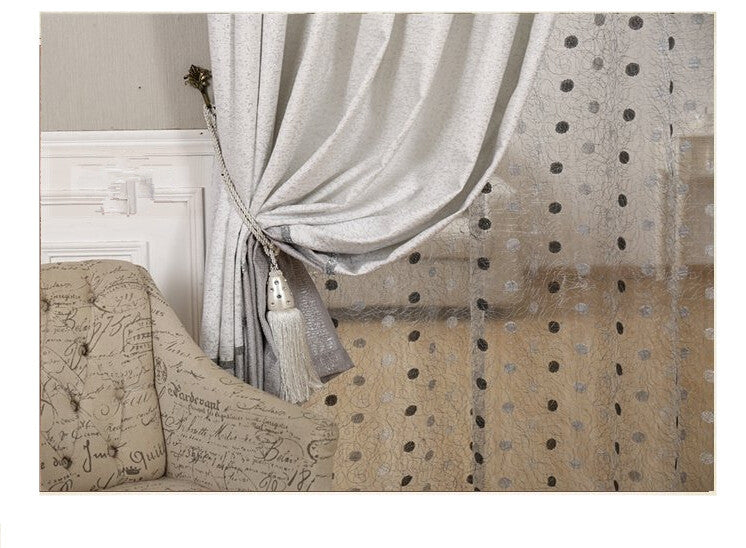 Shopi Vella simple blackout curtains with elegant tiebacks hanging beside a decorative sofa