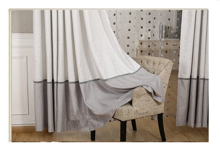 Shopi Vella comforter styled with simple blackout curtains in white and gray for a cozy room
