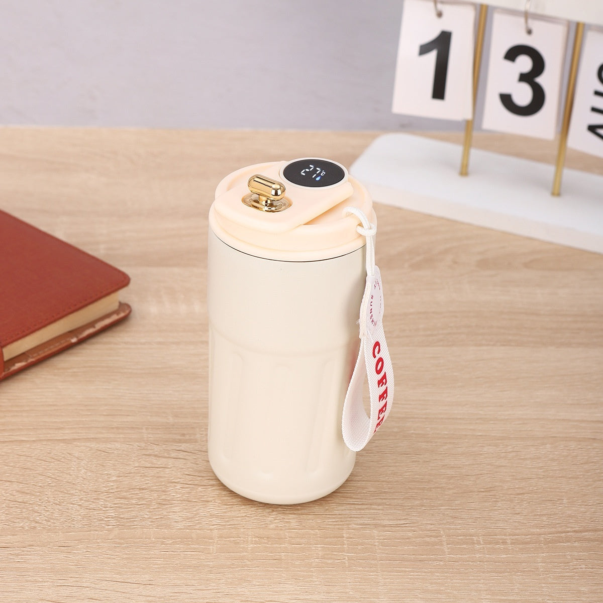 Shopi Vella smart thermal coffee mug in cream color with digital temperature display and carrying strap