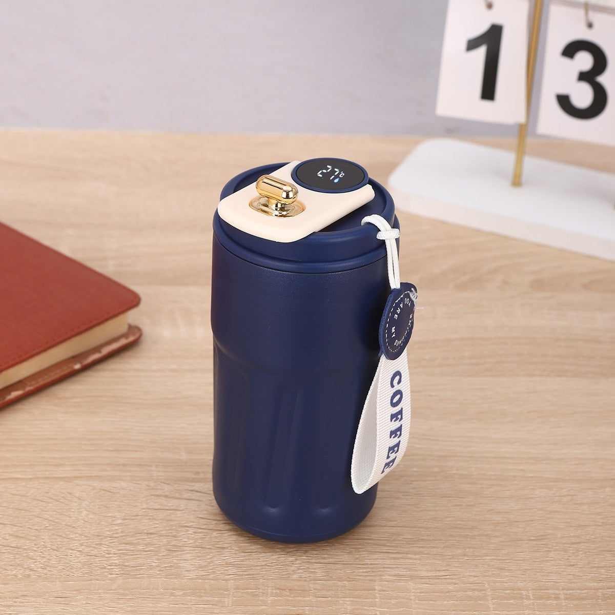 Shopi Vella smart thermal coffee mug in navy blue with digital temperature display and coffee strap