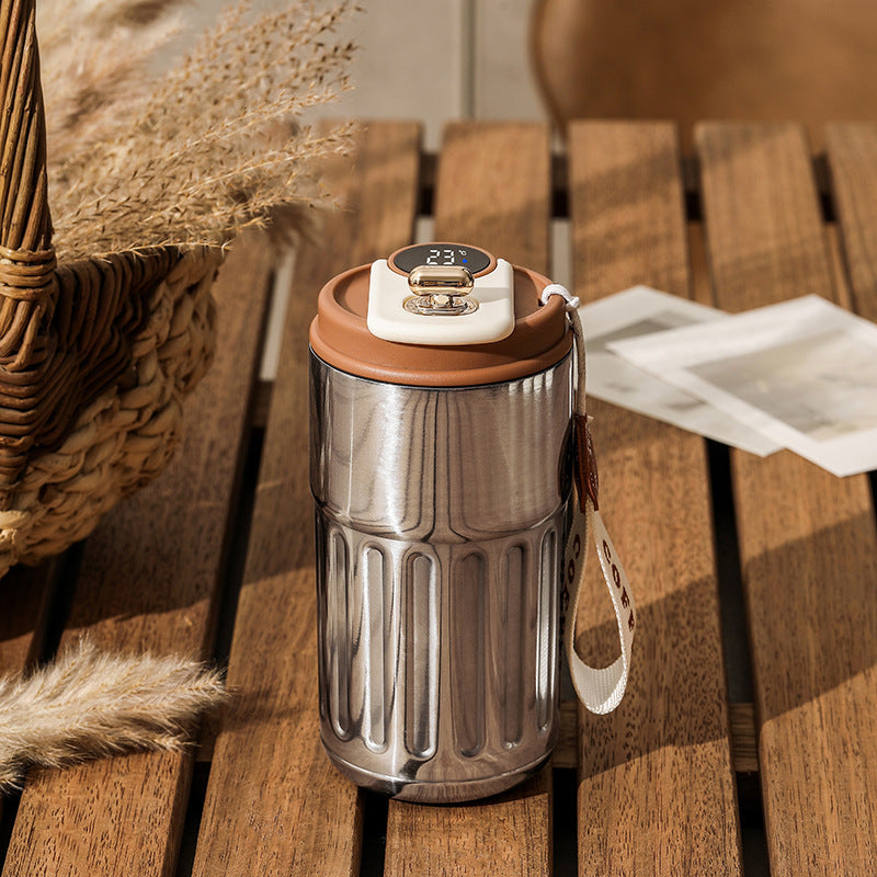 Shopi Vella smart thermal coffee mug with digital temperature display and leather strap on wooden table