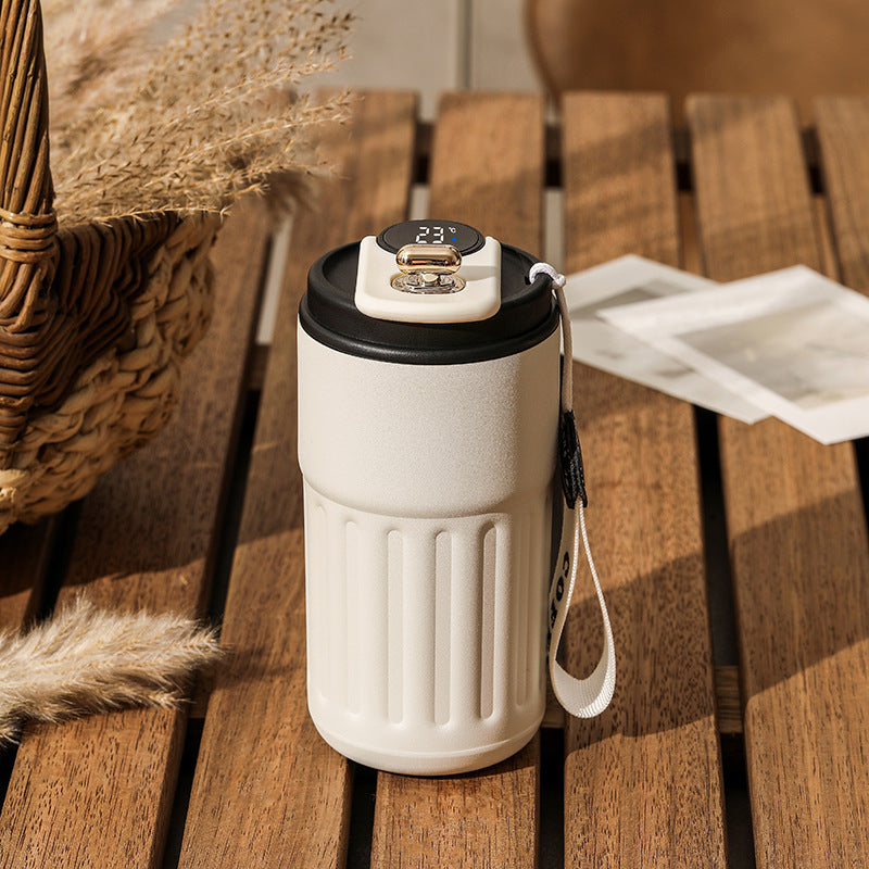 Shopi Vella smart thermal coffee mug with digital temperature display and carrying strap on wooden table