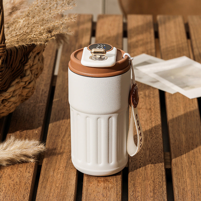 Shopi Vella smart thermal coffee mug in white with brown lid and temperature display on wooden table