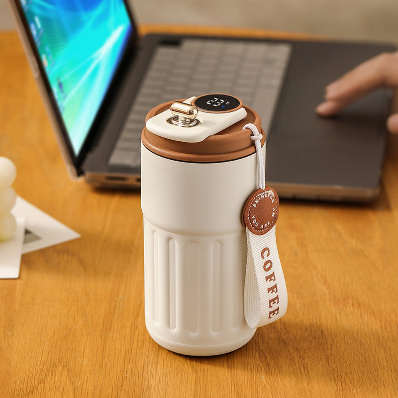 Shopi Vella smart thermal coffee mug with brown lid and digital temperature display on wooden table