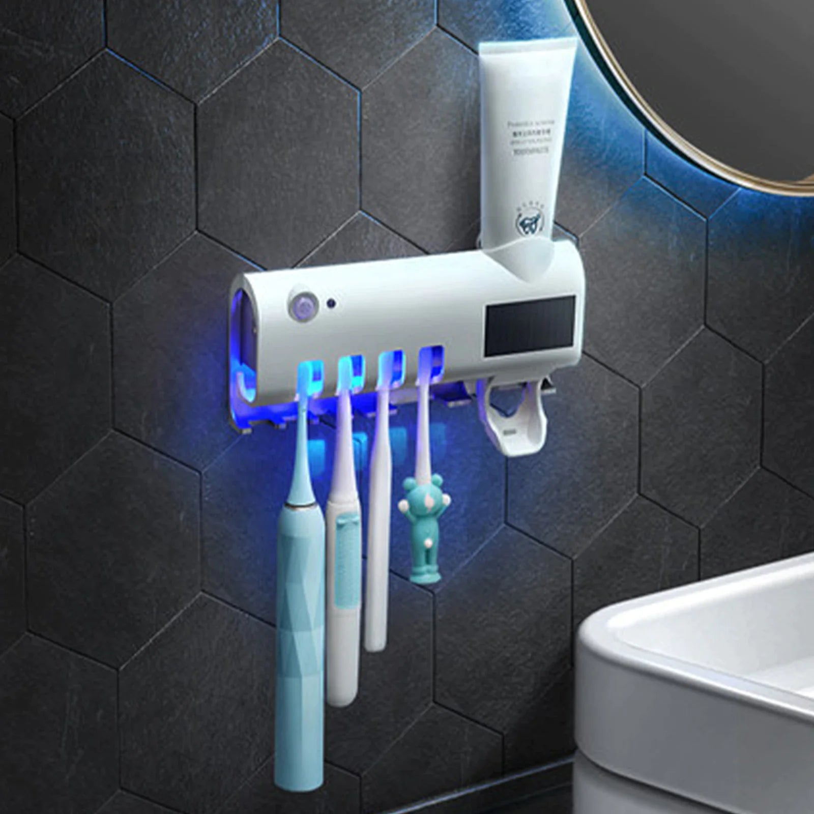 Smart UV toothbrush sterilizer mounted on black hexagon tile wall with multiple toothbrushes and toothpaste
