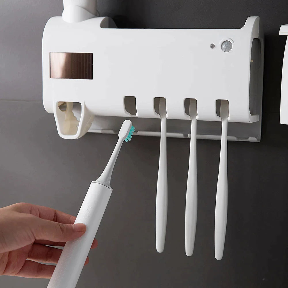 Wall-mounted smart UV toothbrush sterilizer with built-in holders and a hand placing an electric toothbrush