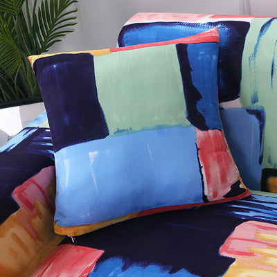 Colorful sofa cushion cover floral print with blue, green, and pink abstract design on a sofa