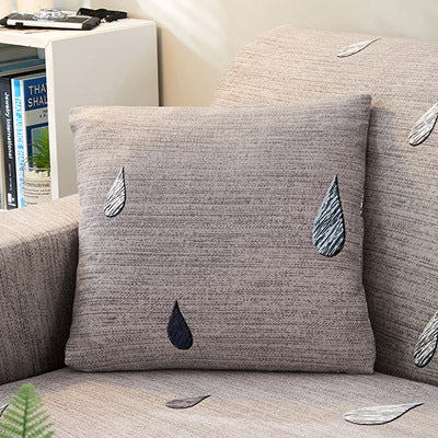 Gray sofa cushion cover floral print with embroidered water drop design on beige sofa