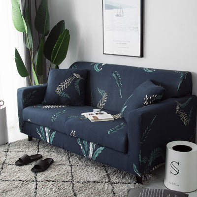 Dark blue sofa with sofa cushion cover floral print featuring green and beige leaf patterns in a modern living room