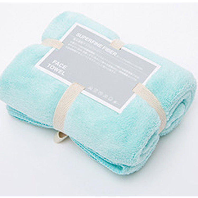 Light blue soft yoga towel for sweat absorption rolled and secured with beige straps