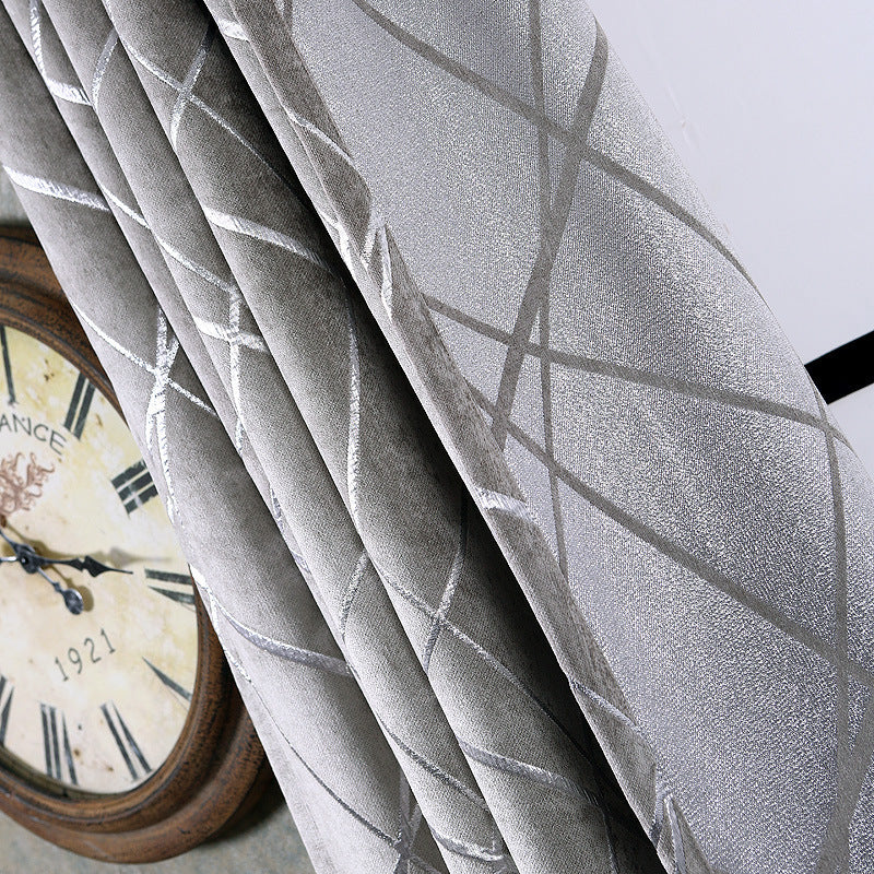 Gray patterned solid color living room curtains hanging next to a vintage wall clock