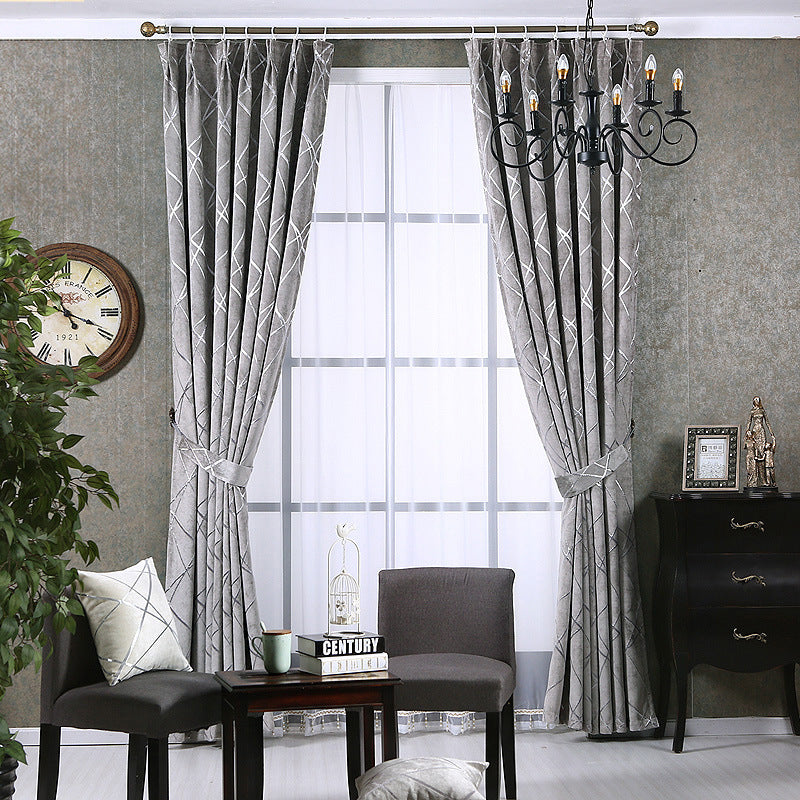 Gray solid color living room curtains hung with tiebacks in a modern living room setup