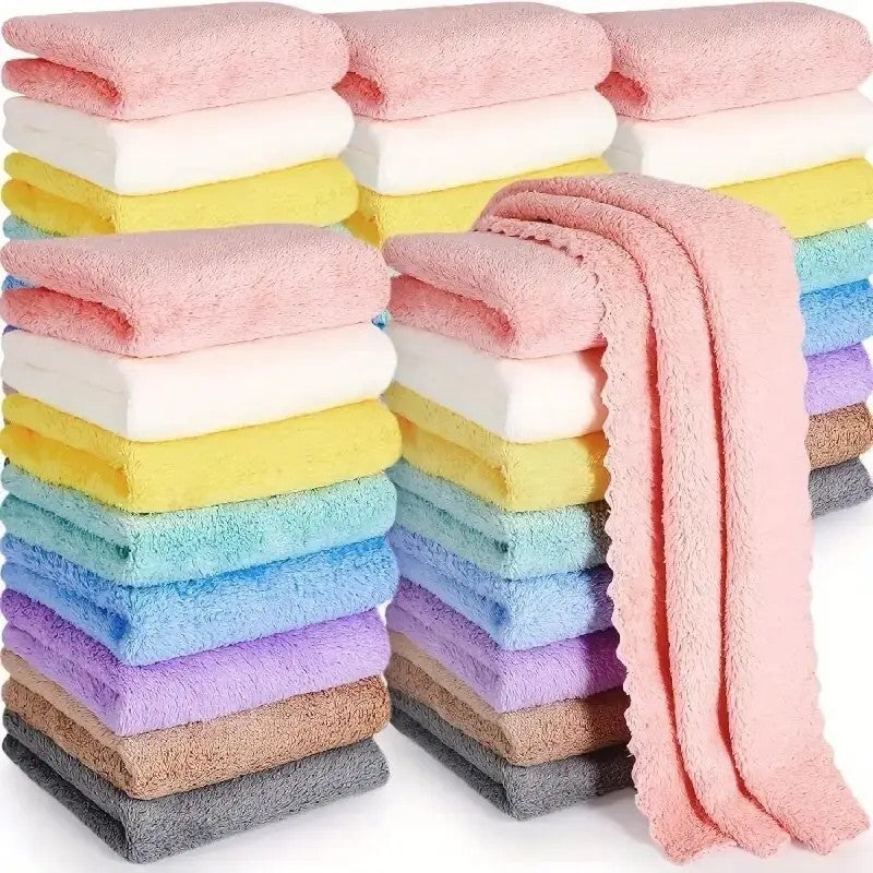 Stack of colorful solid color travel towels by Shopi Vella in pastel shades including pink, yellow, blue, and white