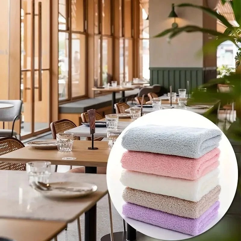 Stack of pastel solid color travel towels including blue, pink, white, beige, and lavender by Shopi Vella