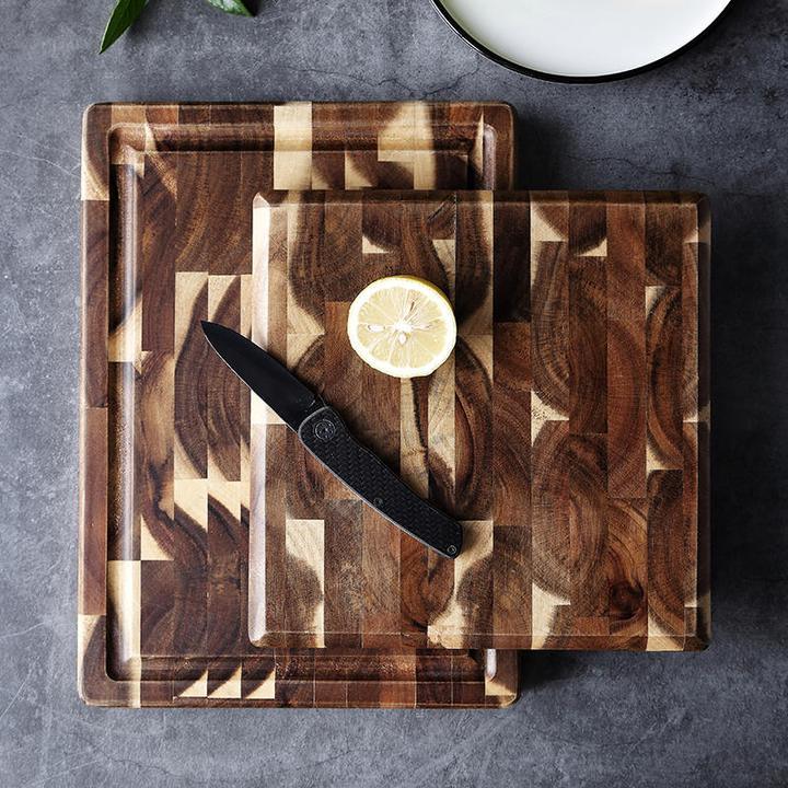 Shopi Vella solid wood cutting board set with two sizes featuring unique wood patterns with a lemon and knife