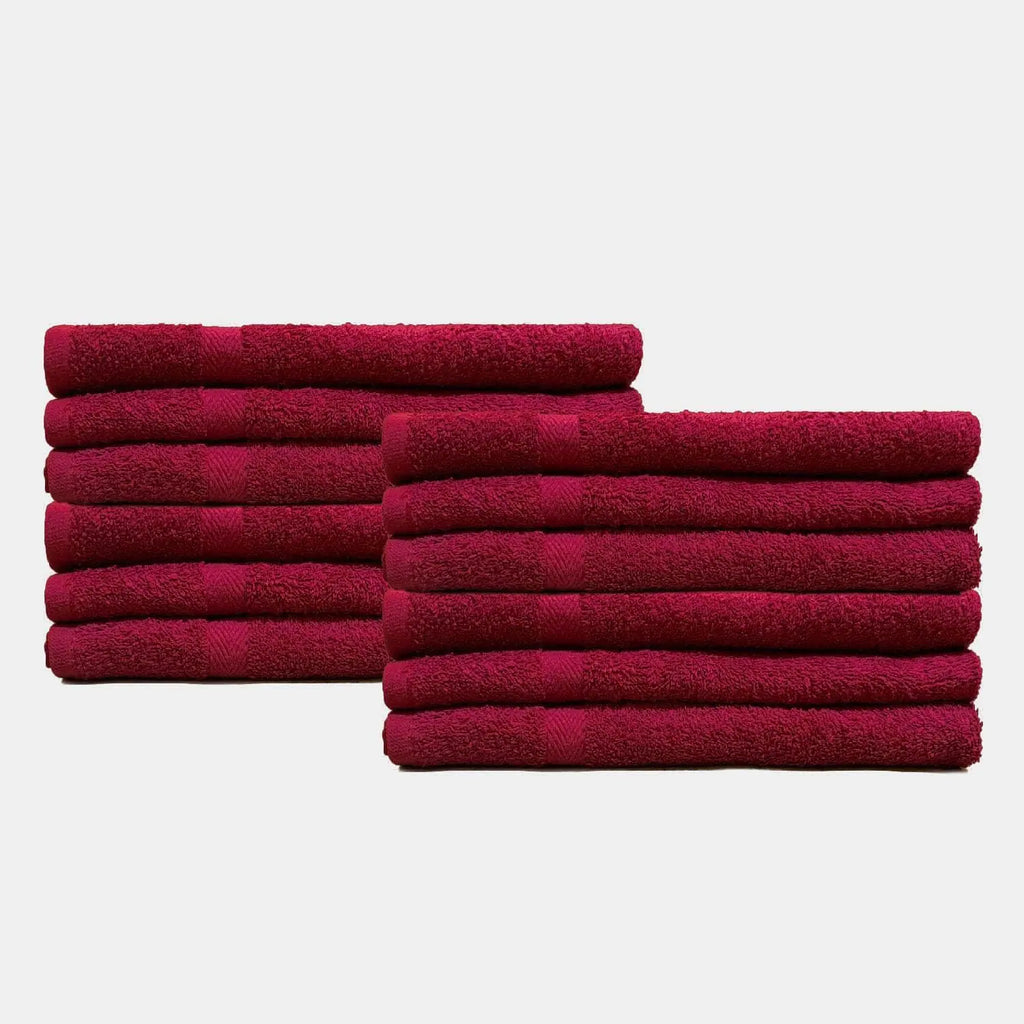 Set of soft burgundy spa towels for facials neatly stacked for professional skincare use