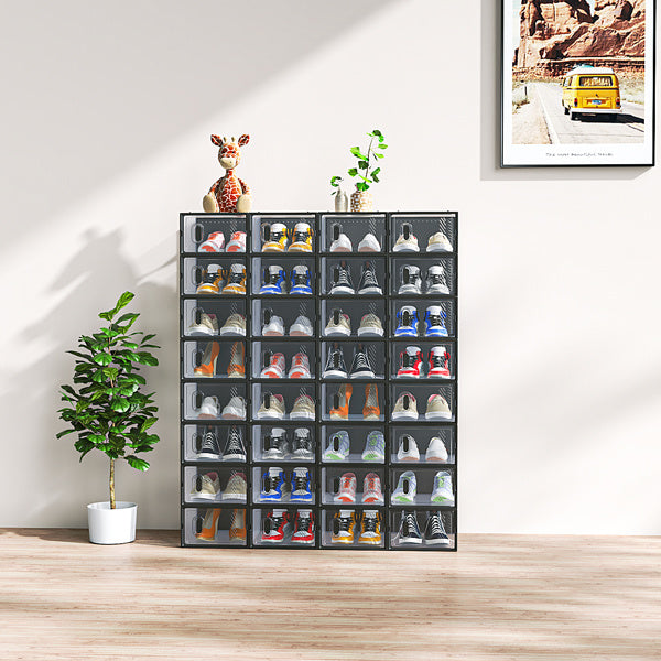 Shopi Vella stackable black plastic shoeboxes neatly organizing various sneakers in a modern living room