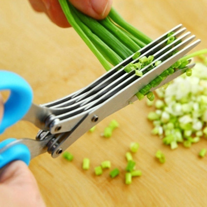 Shopi Vella stainless steel herb scissors cutting fresh green herbs on wooden surface