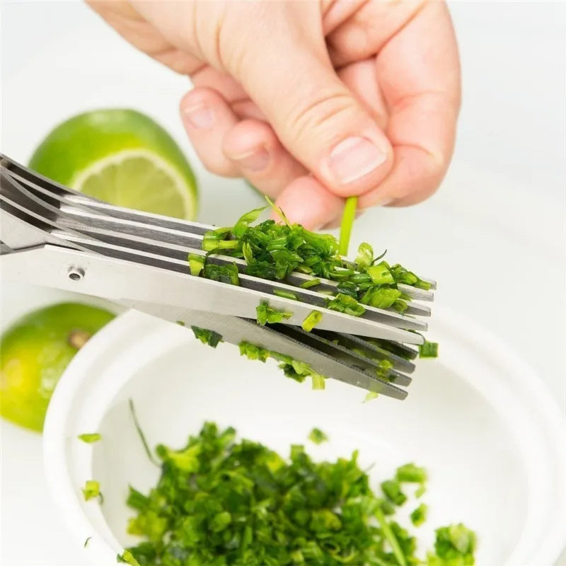 Shopi Vella stainless steel herb scissors cutting fresh green herbs over white bowl