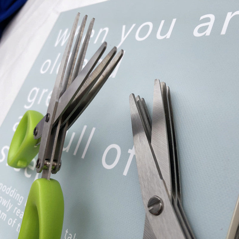 Shopi Vella stainless steel herb scissors with multiple blades and green handles for kitchen storage