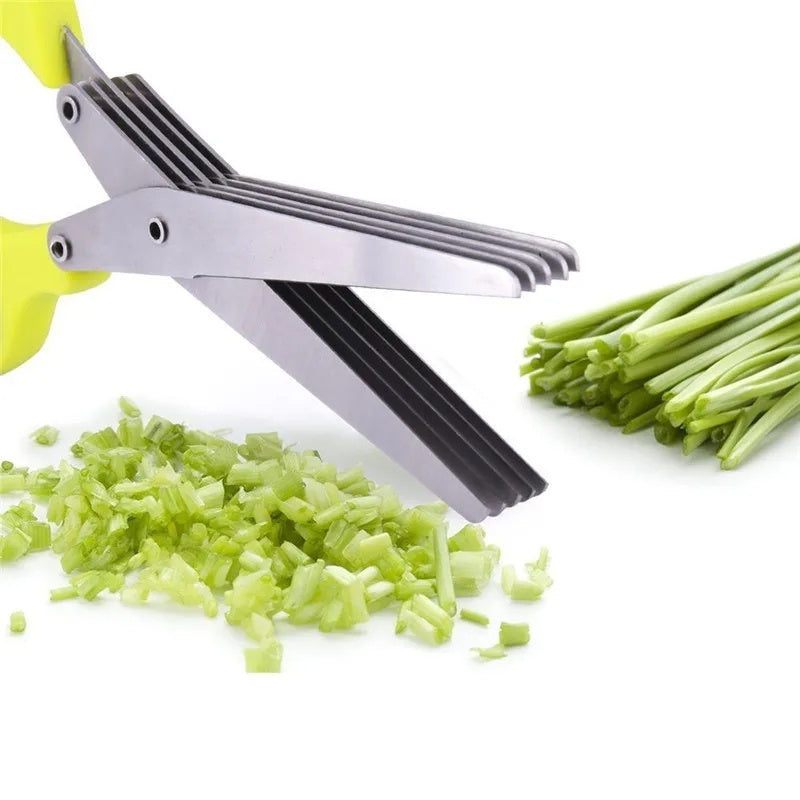Shopi Vella stainless steel herb scissors with multiple blades chopping fresh green herbs on white background