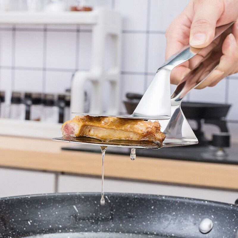 Shopi Vella stainless steel kitchen tongs lifting cooked meat above a frying pan in a modern kitchen