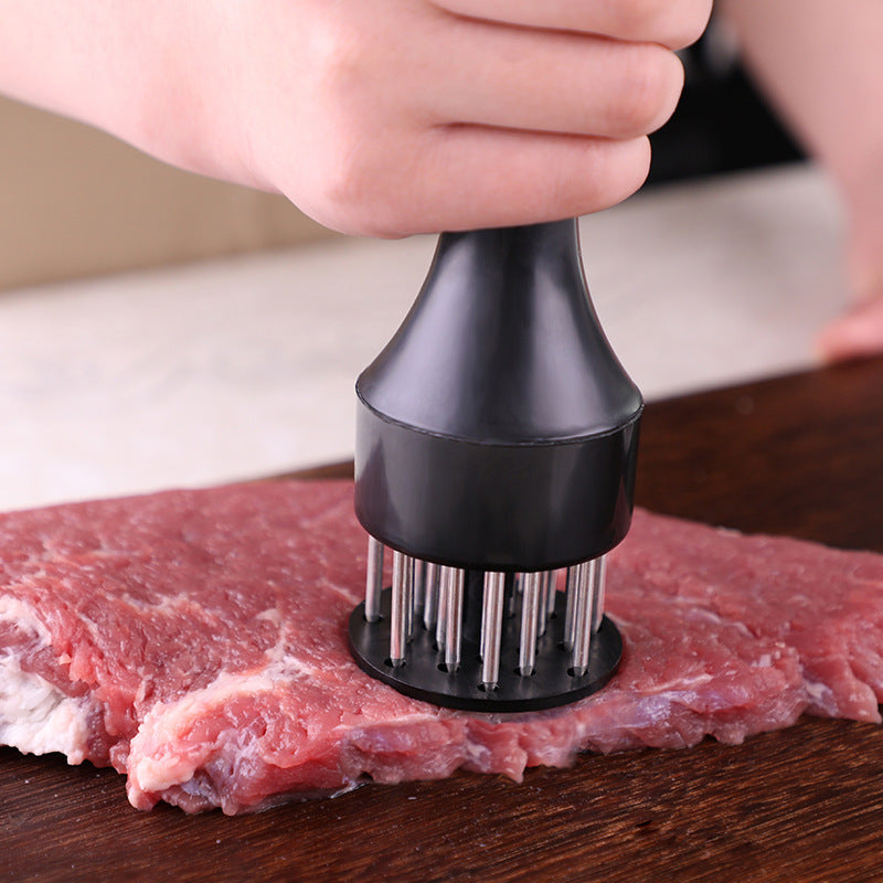 Shopi Vella stainless steel meat tenderizer being used on raw meat with black handle