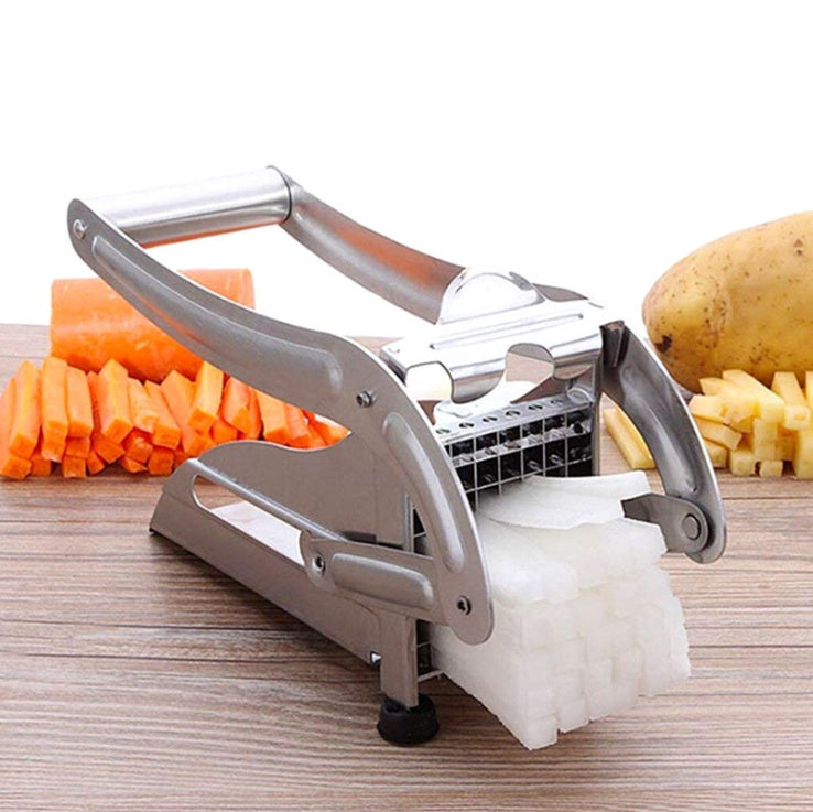 Shopi Vella stainless steel vegetable cutter slicing white radish with cut carrots and potatoes in background