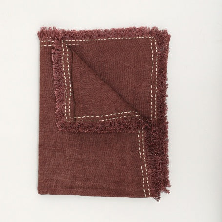 Shopi Vella burgundy cushion cover with fringed edges and white stitched detailing in stonewashed linen throw blanket style