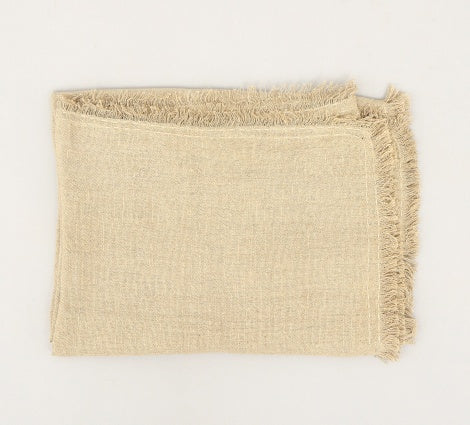 Shopi Vella stonewashed linen throw blanket folded with fringed edges in beige color