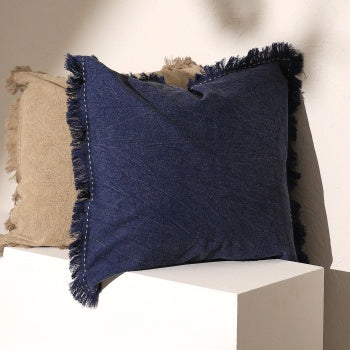 Shopi Vella stonewashed linen throw pillow case in navy blue with fringe edges on white surface