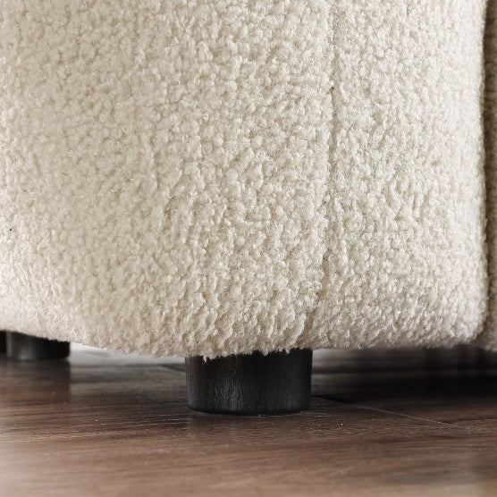 Close-up of a stylish apartment sofa leg with soft cream textured fabric on wooden floor