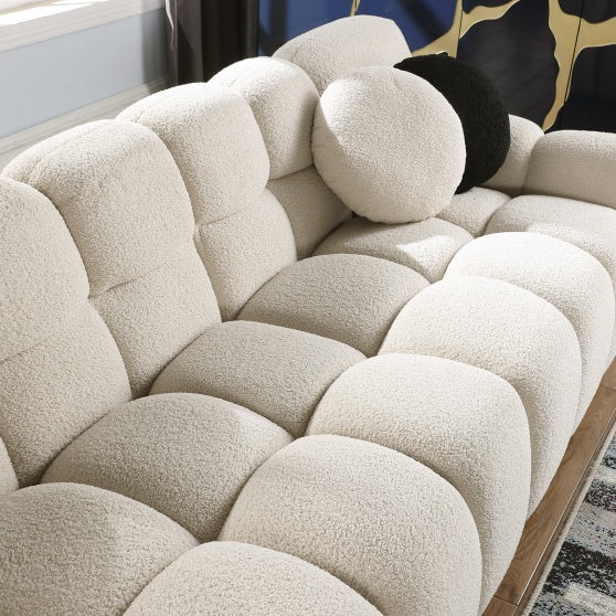 Shopi Vella stylish apartment sofa with plush textured cushions and round pillows in neutral tones