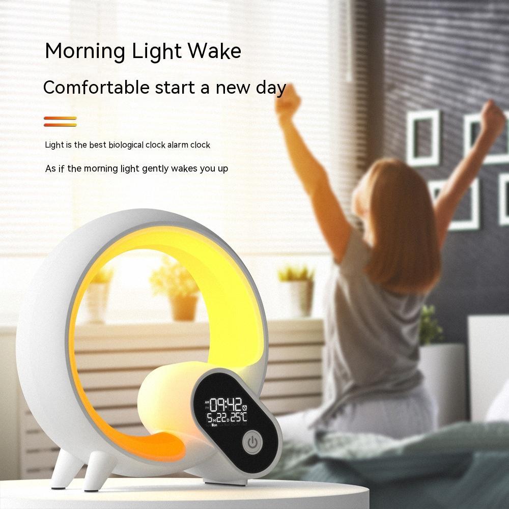 Sunrise alarm clock with Bluetooth speaker by Shopi Vella emitting soft morning light on a bedside table
