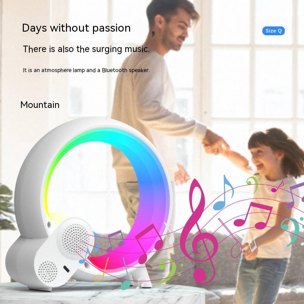 Sunrise alarm clock with Bluetooth speaker in white glowing multicolor light with father and child dancing
