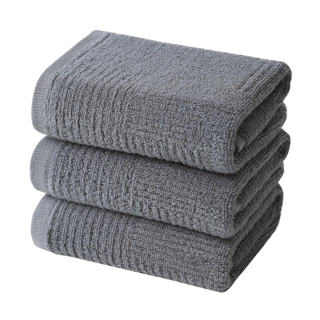Stack of gray terry cloth hand towels for kitchen made from soft absorbent fabric