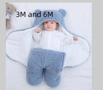 Baby wrapped in Shopi Vella thick winter baby quilt with blue hood and soft fluffy interior for 3M and 6M infants