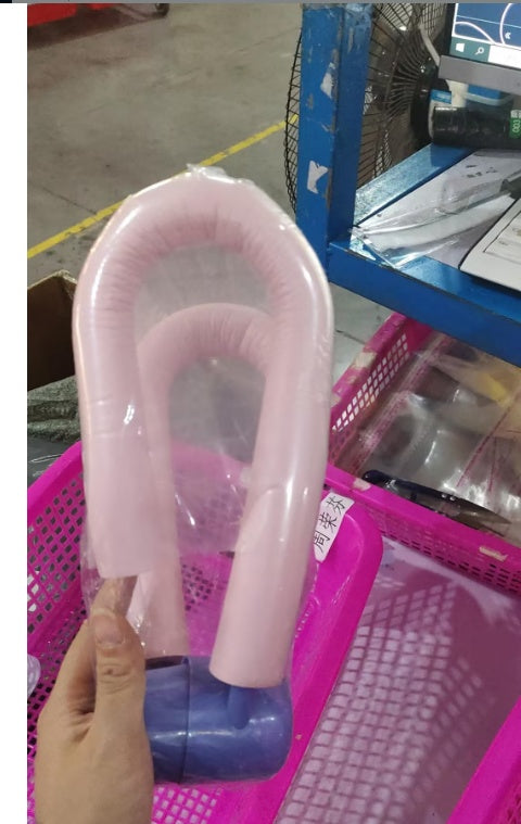 Shopi Vella pink thigh master exercise equipment held over a pink plastic basket in storage area