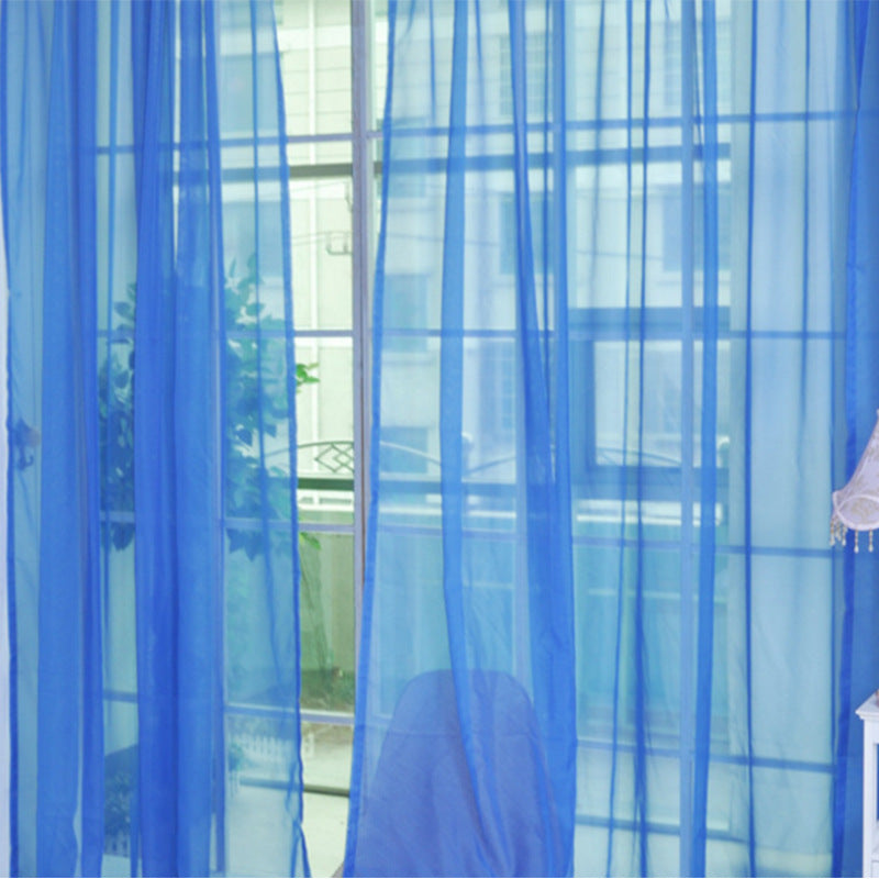 Blue transparent tulle window curtains softly filtering light in a bright room